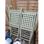 Four folding green painted wooden garden chairs