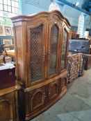 Drexel Heritage; a reproduction bookcase having three glazed doors with cupboards below