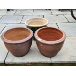 A pair of garden pots and one other