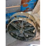 A pair of cast iron wheels having seven spokes each, 51cms