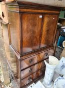 A reproduction mahogany cupboard having three long drawers below and sundry furniture