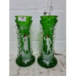 A pair of Mary Gregory green vases decorated figures