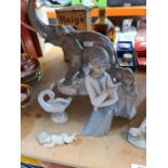 A Lladro figure of two elephants (one tusk missing) six other Lladro figures and one similar