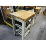 A small kitchen work station, having oak top and a folding table