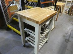 A small kitchen work station, having oak top and a folding table