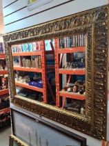 A reproduction gilt framed mirror, depicting Brighton Pier, having bevelled glass