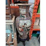 A large modern oriental vase, the panels decorated figures, 92cms, on wooden decorative stand