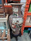 A large modern oriental vase, the panels decorated figures, 92cms, on wooden decorative stand