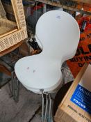 A set of four white painted chairs on metal legs
