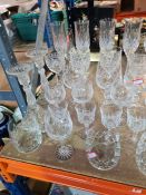 A selection of crystal glasses, including Champagne, Brandy, etc, candlesticks and water jugs