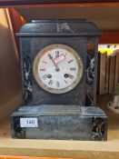 A late Victorian slate mantel clock having presentation plaque