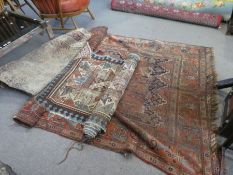 An Old Caucasian rug, having repeated central design, a geometric rug and 1 other