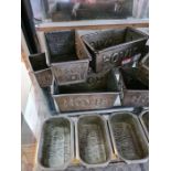 A quantity of small metal loaf tins for Hovis bread and one large stoneware bread bin