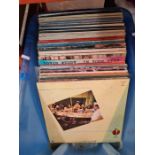A box of vinyl LP records, mainly 70s and 80s pop, some Beatles and Rolling Stones examples