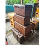 Two old large trunks, two medium sized trunks and a leather style case