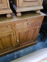 A modern pine sideboard having three drawers