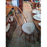 A late 20th century, Ercol dining table having one leaf and a set of four matching dining chairs hav