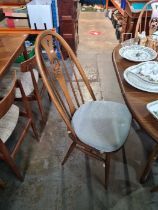 A late 20th century, Ercol dining table having one leaf and a set of four matching dining chairs hav