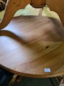 A modern circular pine kitchen table and a set of four stick-back chairs, the table 121cm