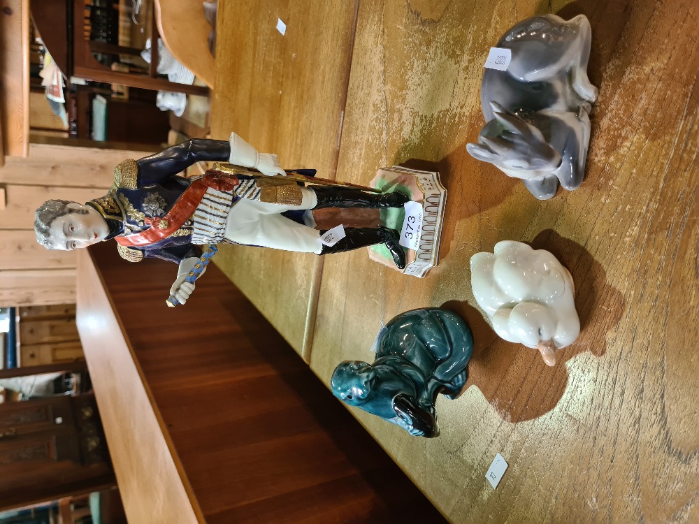 A Dresden figure of military soldier, two Copenhagen figures and a Poole otter