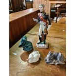 A Dresden figure of military soldier, two Copenhagen figures and a Poole otter