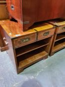 A pair of reproduction bedside tables having military style handles each having two drawers and open