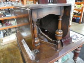 A 1930s oak gateleg dining table