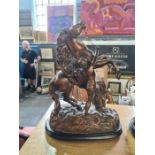 A pair of late 19th century bronzed spelter Marly horse sculptures after Coustou on wooden bases, 45