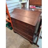 An antique oak bureau having four long graduated drawers, late 18th Century