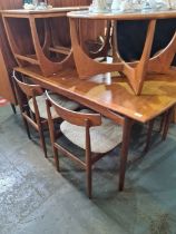 A set of 6 1970's G Plan dining chairs having carved fox rail and an extending teak dining table wit