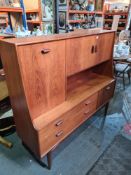 A 1970s G-Plan style wall cupboard having 2 long drawers