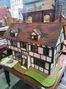 Clive Addis, An individually built Tudor dolls house in 1/12th scale, cost £3200 in 2004, complete w