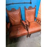 A pair of late Victorian mahogany open armchairs having carved top rail