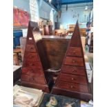 A pair of pyramid style chests having 5 drawers to each