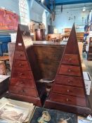 A pair of pyramid style chests having 5 drawers to each