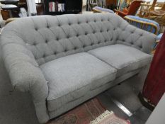 A modern button back settee having grey upholstery, retailed by John Lewis