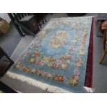 A modern Chinese rug having floral design in a turquoise field, 252cm x 157cm