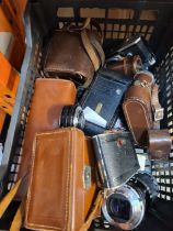 A tray of vintage cameras, lenses and similar