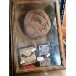 A vintage display containing 1950s leather football and other related items