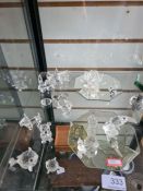 A shelf of small Swarovski crystal figures, mainly boxed