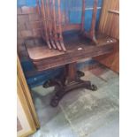 A Victorian rosewood fold over card table on spread base