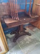 A Victorian rosewood fold over card table on spread base