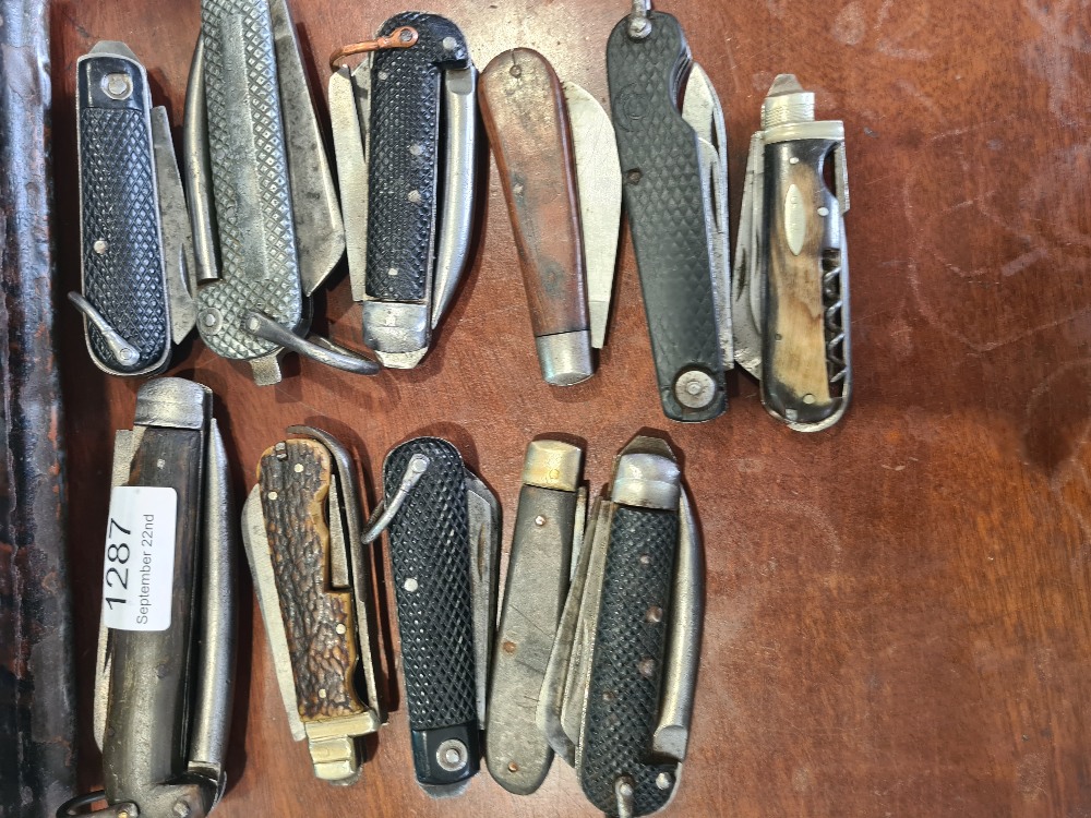 A collection of folding knives, some Military to include some 19th Century examples