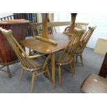 A vintage Ercol oblong dining table having elm top and set of 6 stickback chairs including 2 carvers