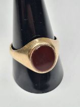 9ct yellow gold signet ring with oval red hardstone panel, size V, marked 375, maker CG & S, approx