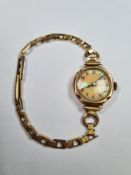 9ct gold cased ladies cocktail watch with pearlescent face and numbered dial, marked 375, 2743 on ro