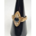 Antique yellow gold dress ring with marquise shaped panel with central sapphire doublet flanked 3 sm