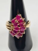 Contemporary 10K yellow gold dress ring set with two rows oval mixed cut rubies in asymetric mount,