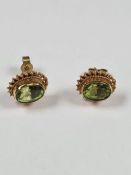 9ct yellow gold stud earrings set with peridots, with twisted frame, marked 375, approx 1.94g