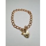 9ct rose gold curblink bracelet with 9ct heart shaped padlock marked 375, each link marked 375, appr